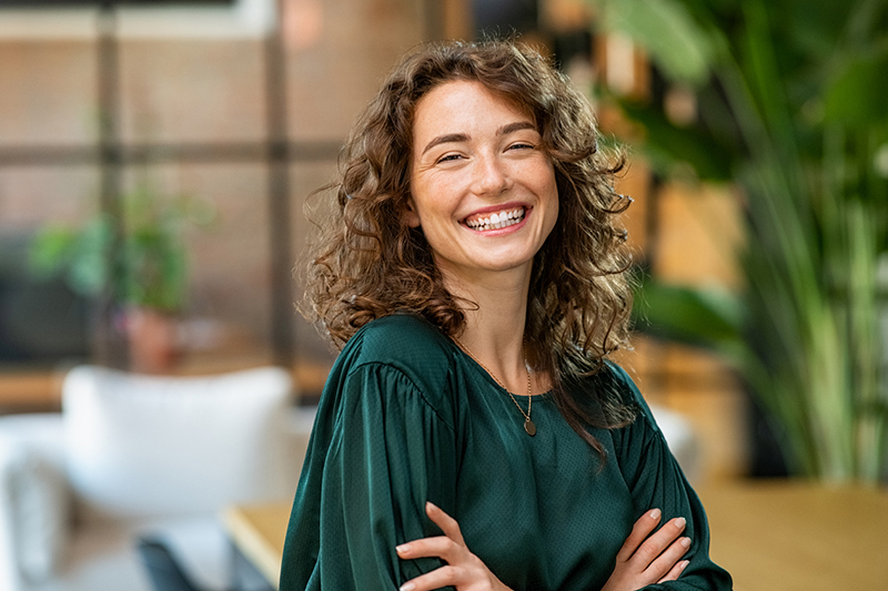 Beautiful woman smiling with crossed arms eyelid lift